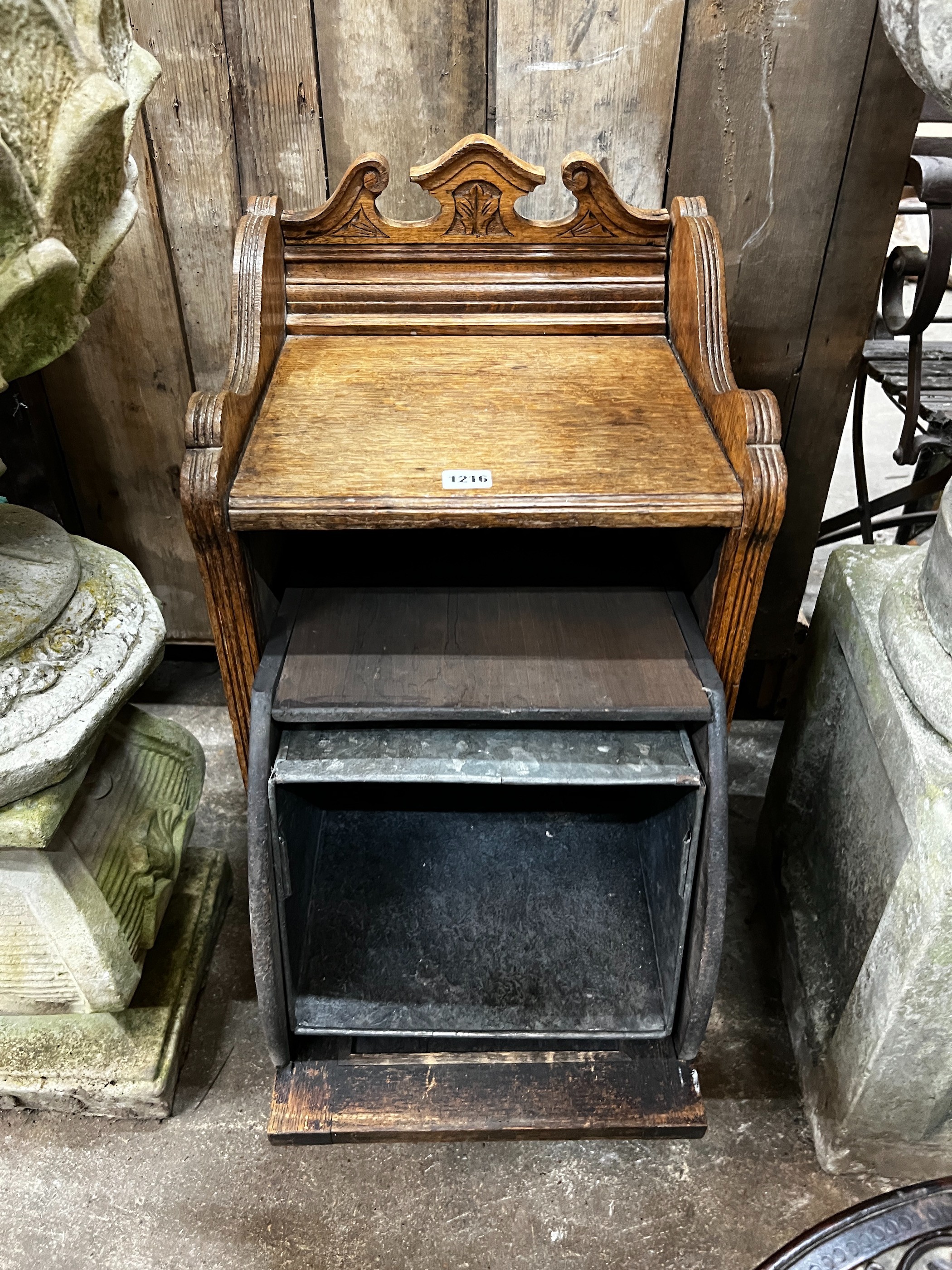A Victorian carved oak coal purdonium, width 38cm, depth 35cm, height 75cm